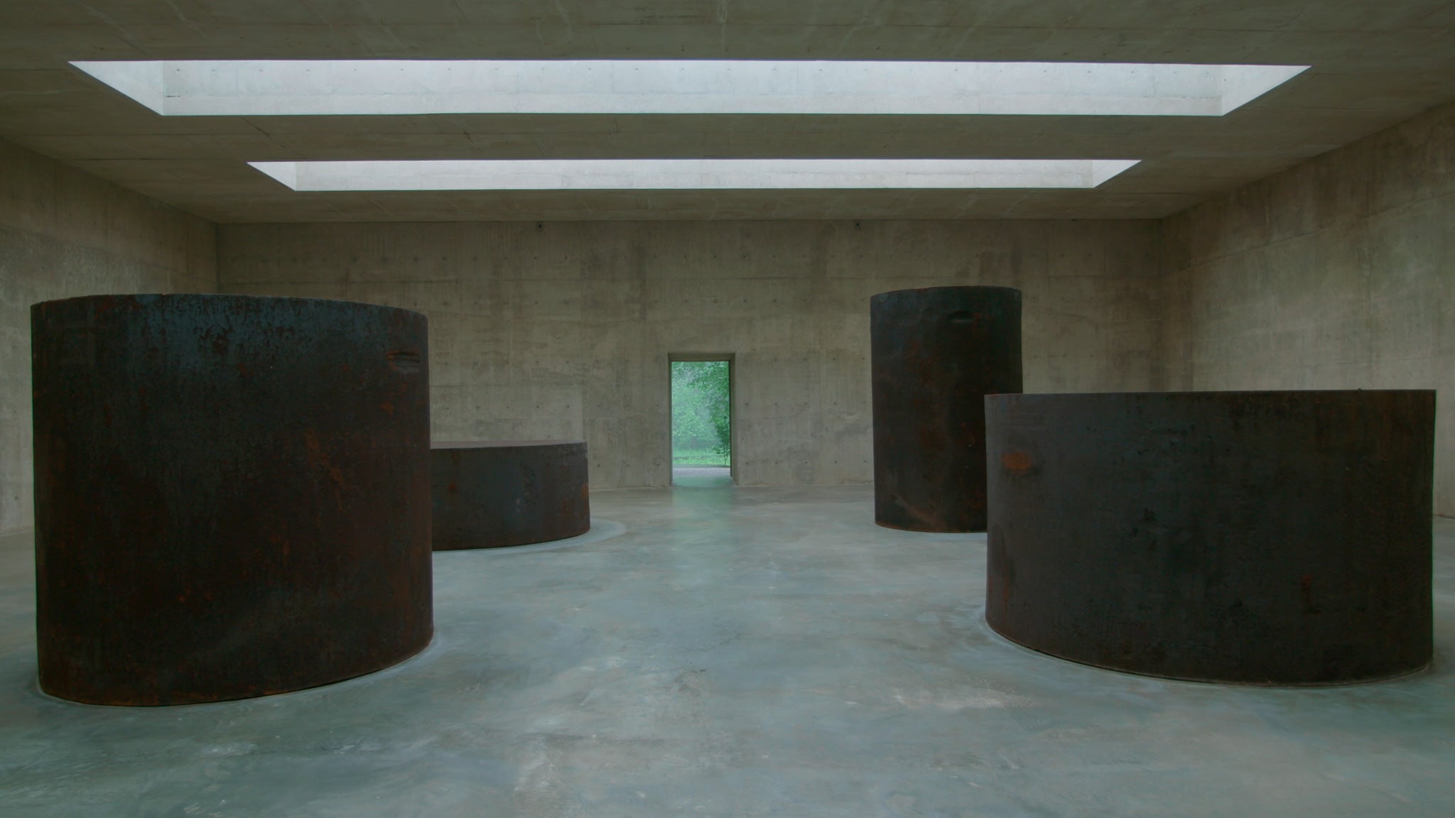 four steel cylinders sit in a concrete building