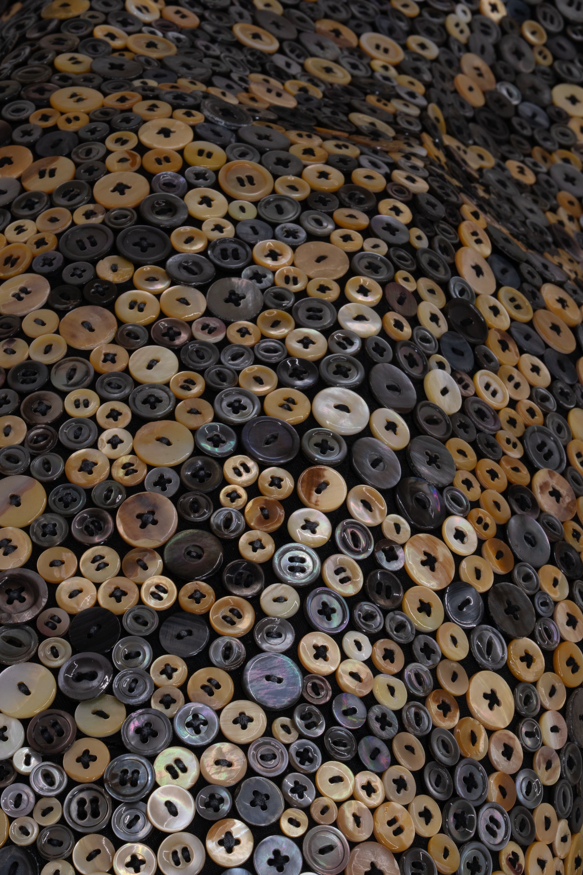 A close up photo of a cascade of iridescent buttons