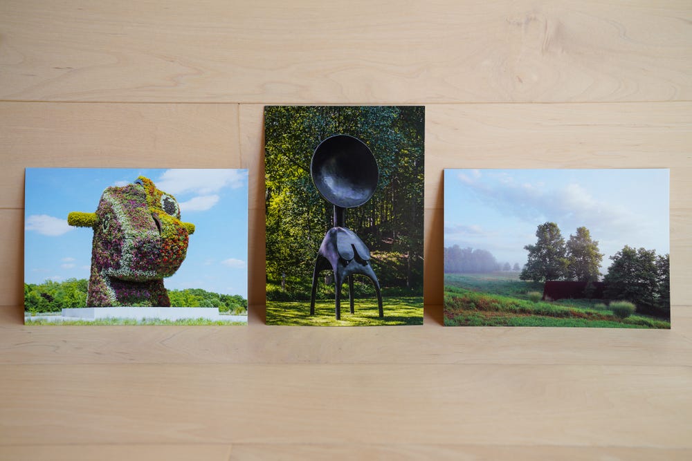 A selection of postcards sits on a wooden surface