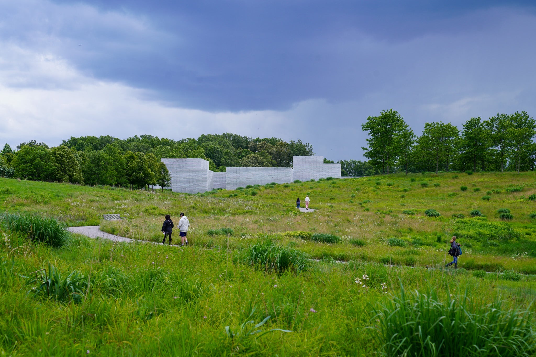 Landscape with winding pathway and blocky buildings in the distance