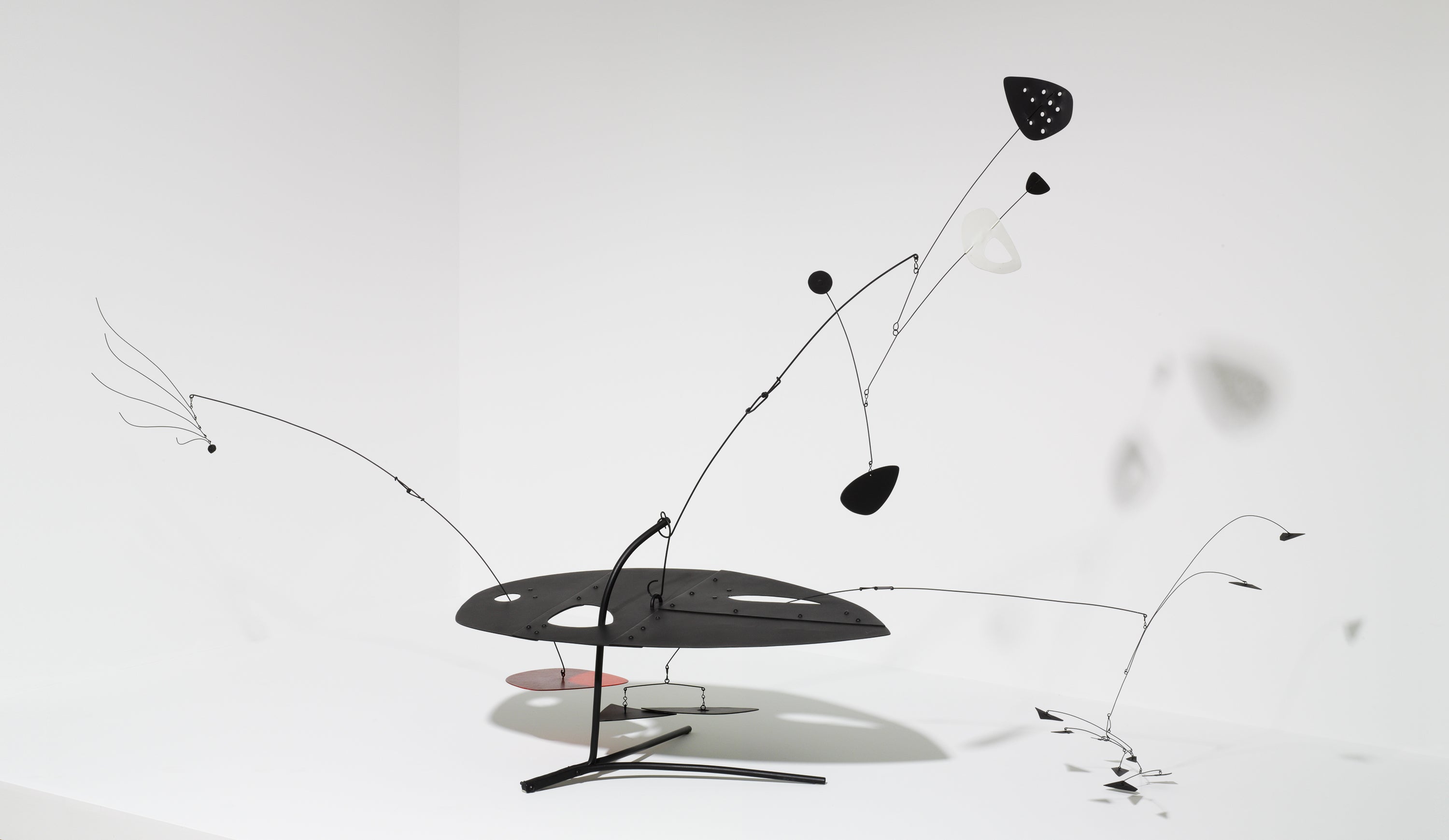 A black kinetic sculpture on a white background.