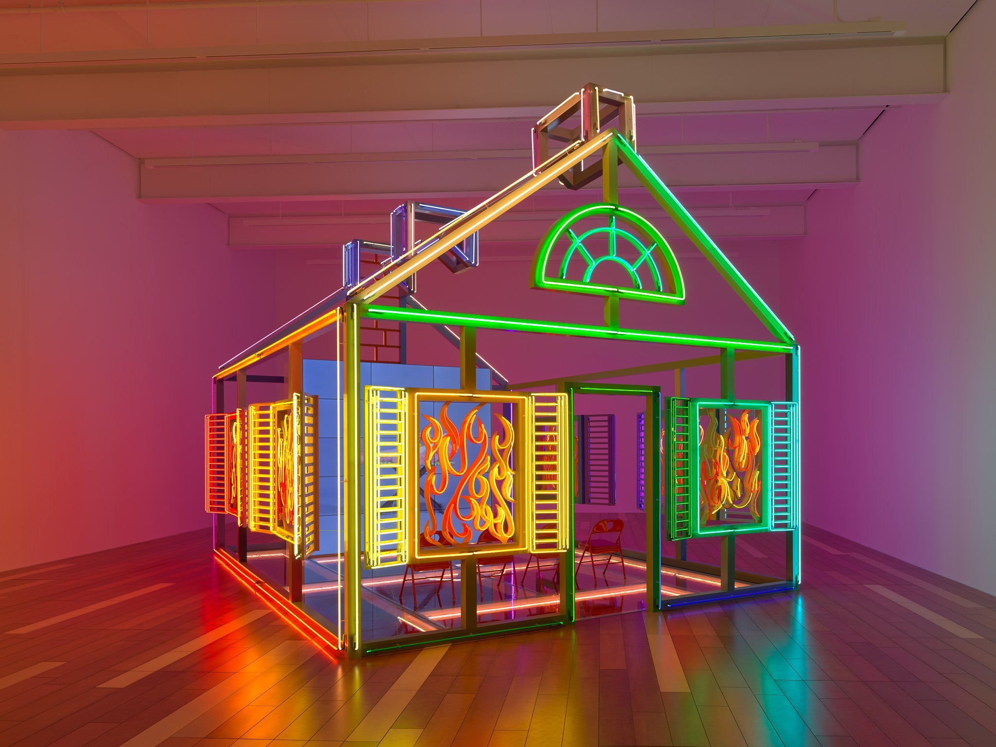 Large neon sculpture of a house on fire