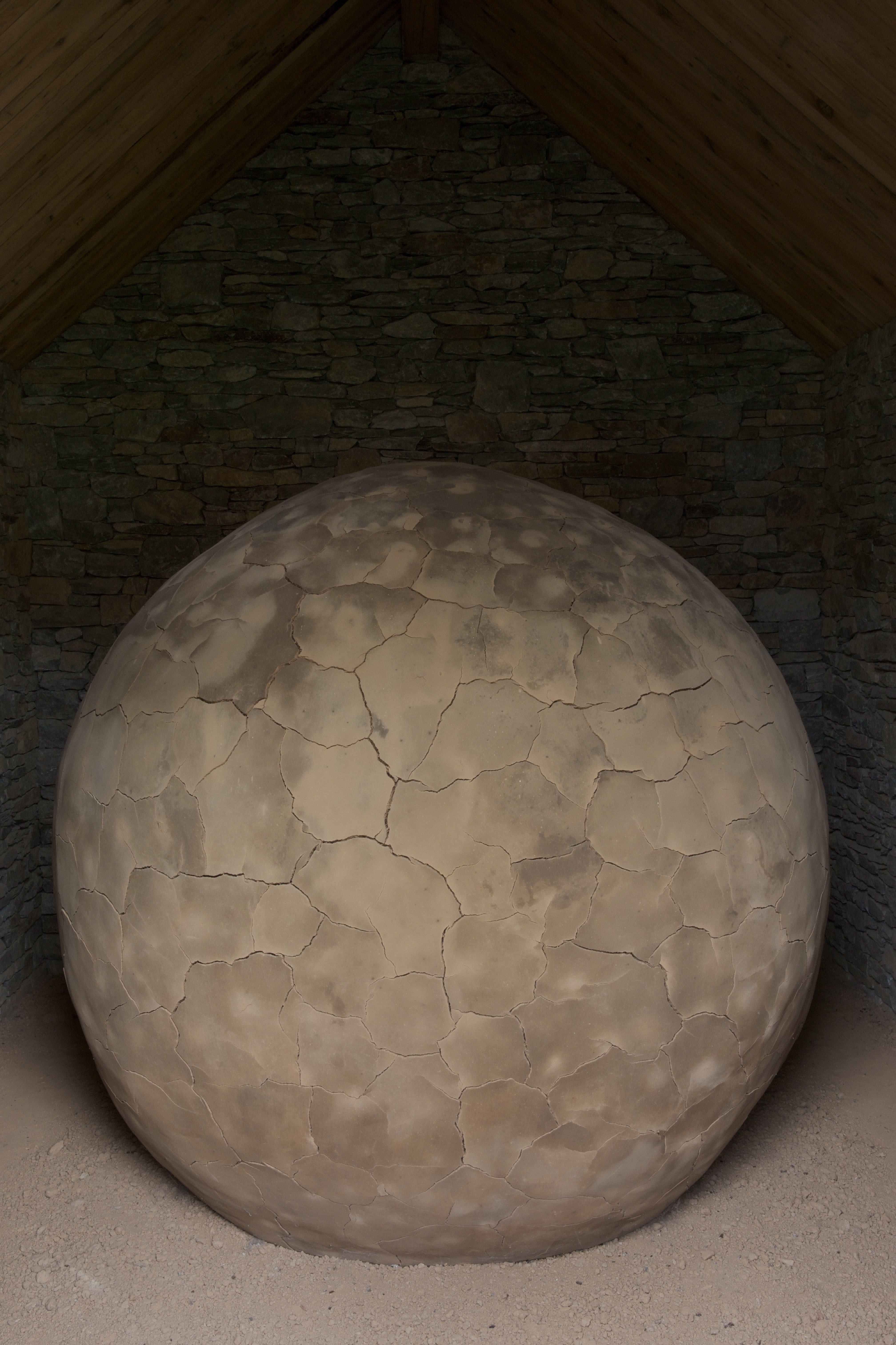 Large clay sphere in a stone structure