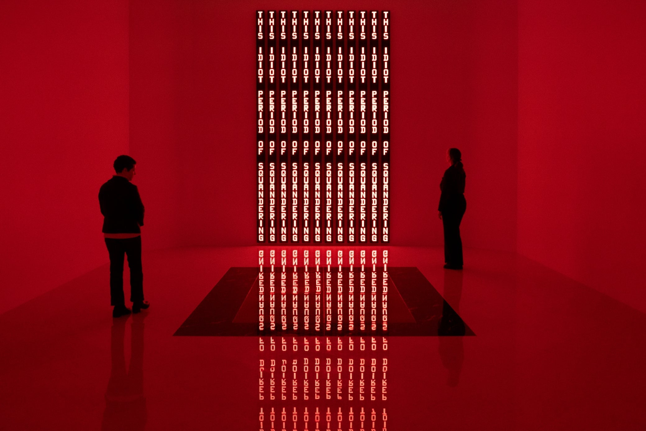 A room illuminated by red LED lights with a floor plaque in the foreground