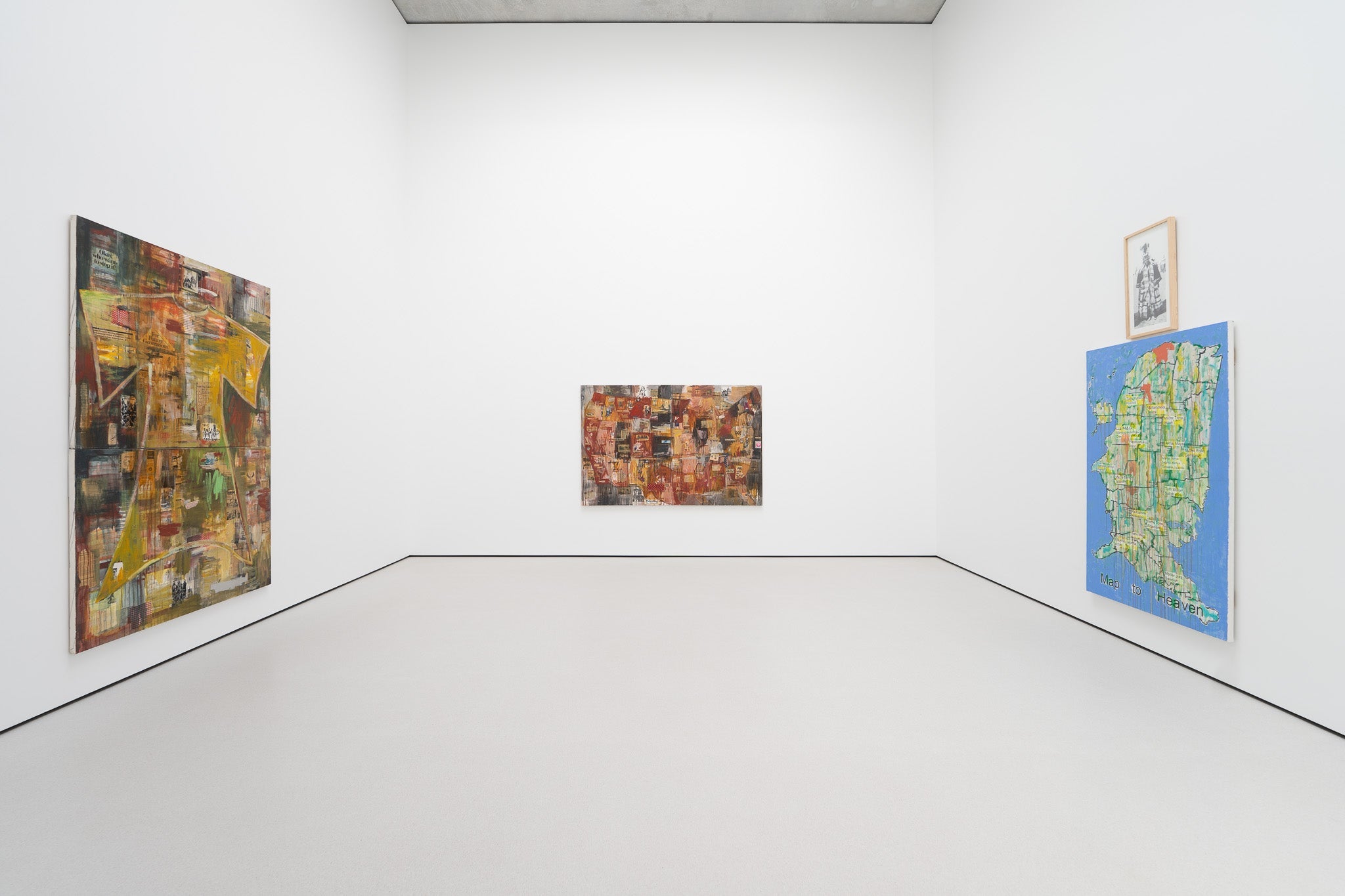 Three mixed media artworks on the three walls of a white room