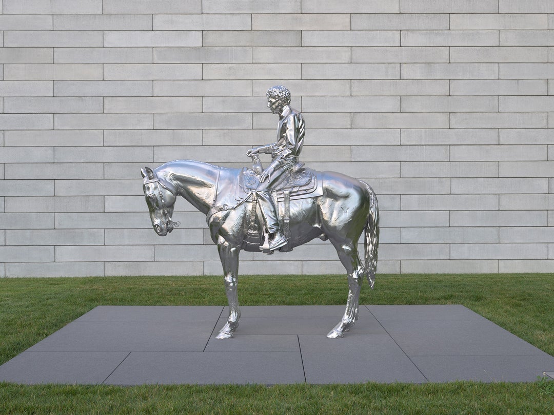 Steel sculpture of a man sitting on a horse