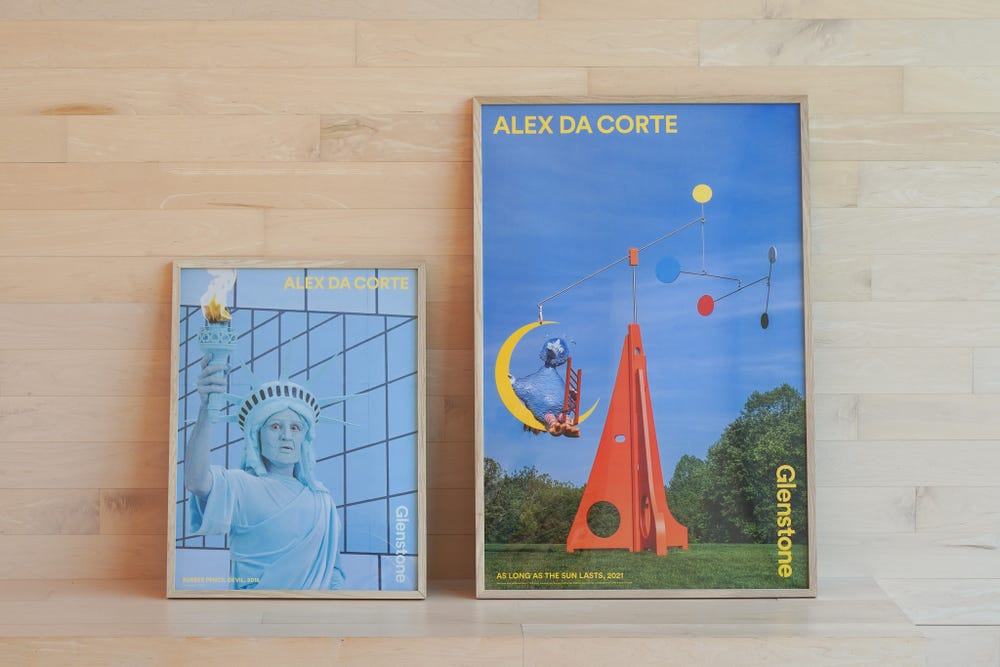 Two posters featuring artwork by Alex Da Corte sit on the Arrival Hall Bench