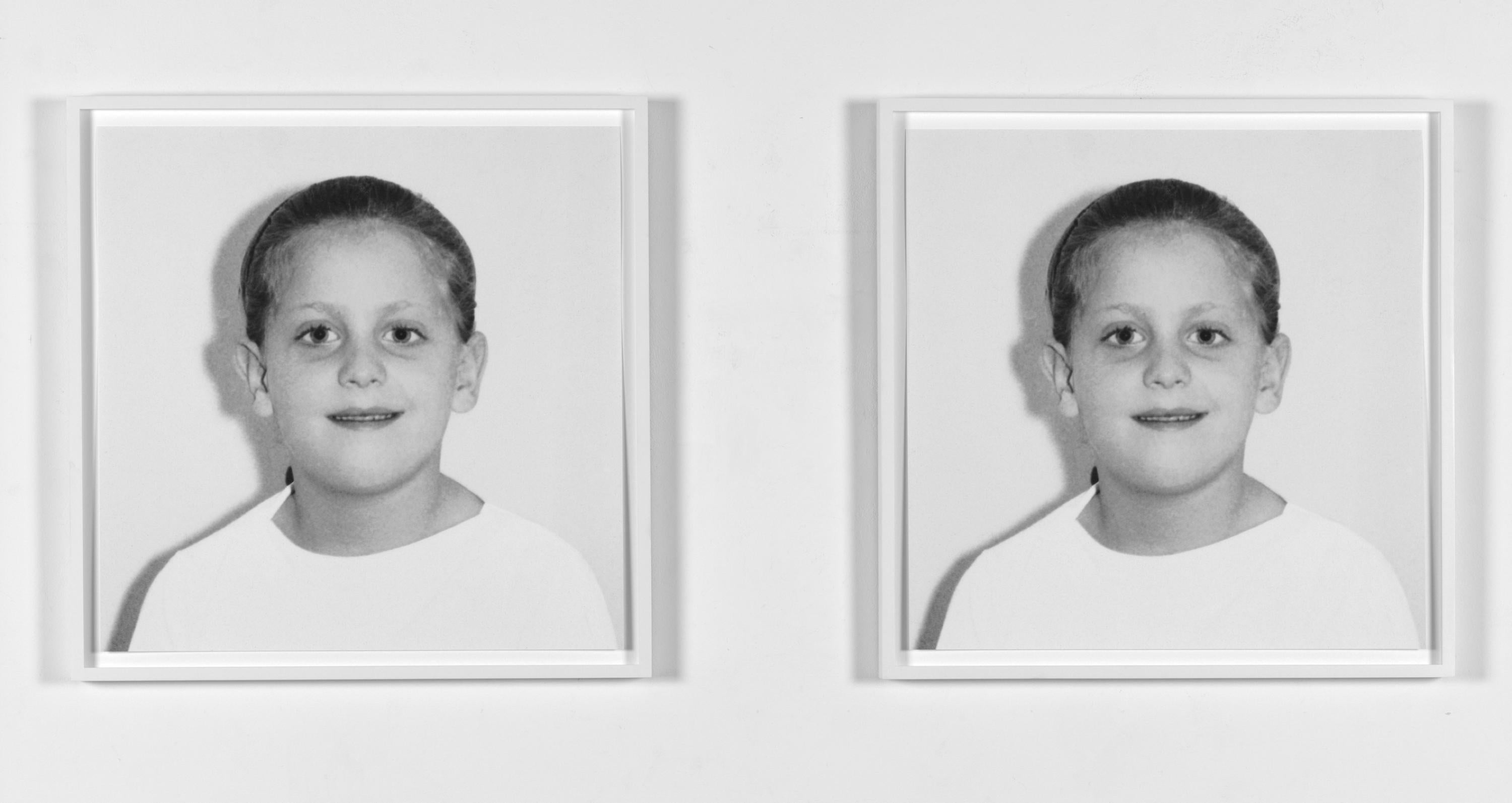 Two framed photo portraits of a child.