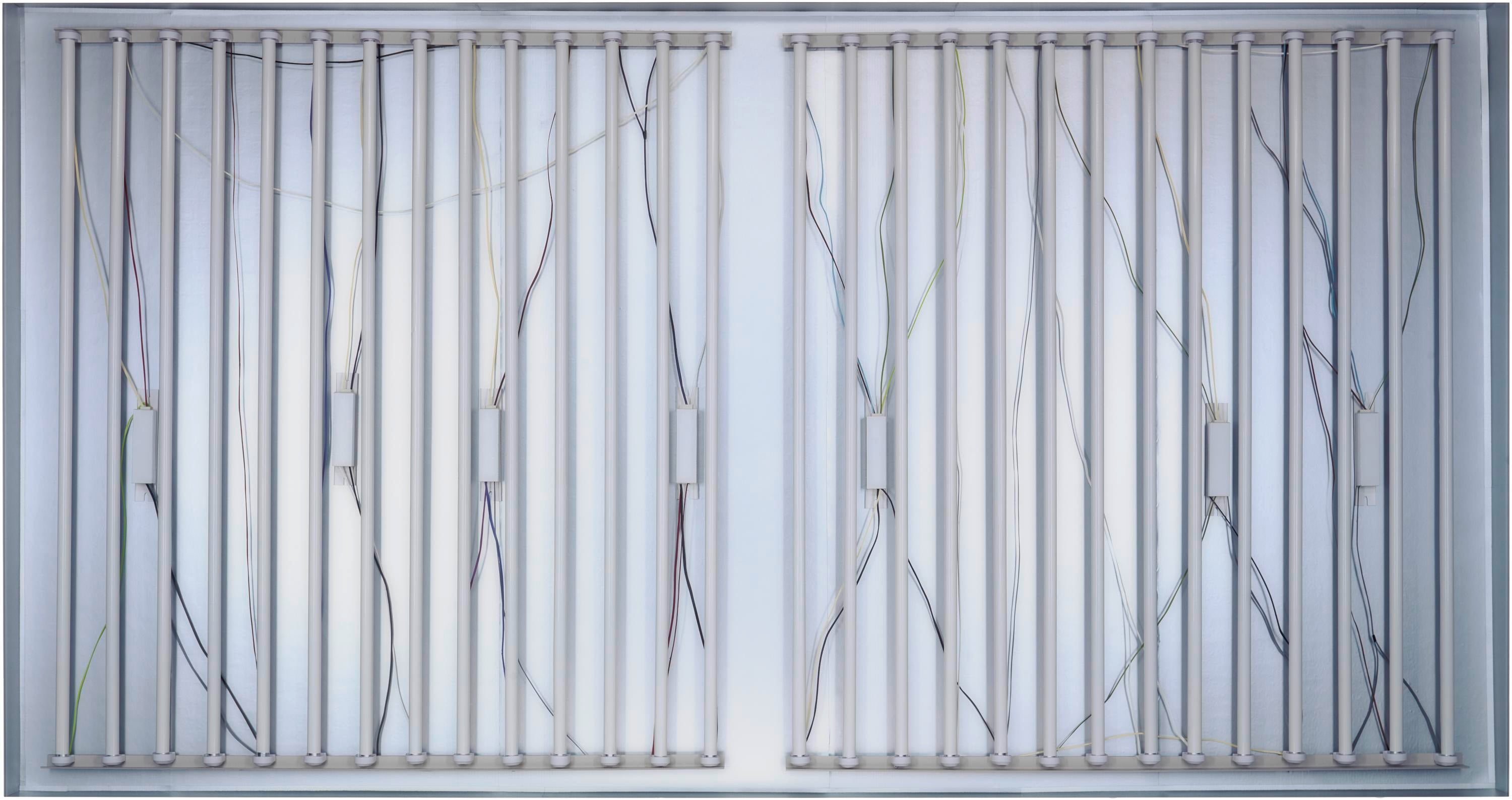 Light tubes and electric wires, constituting the interior of a lighted sign or lightbox.