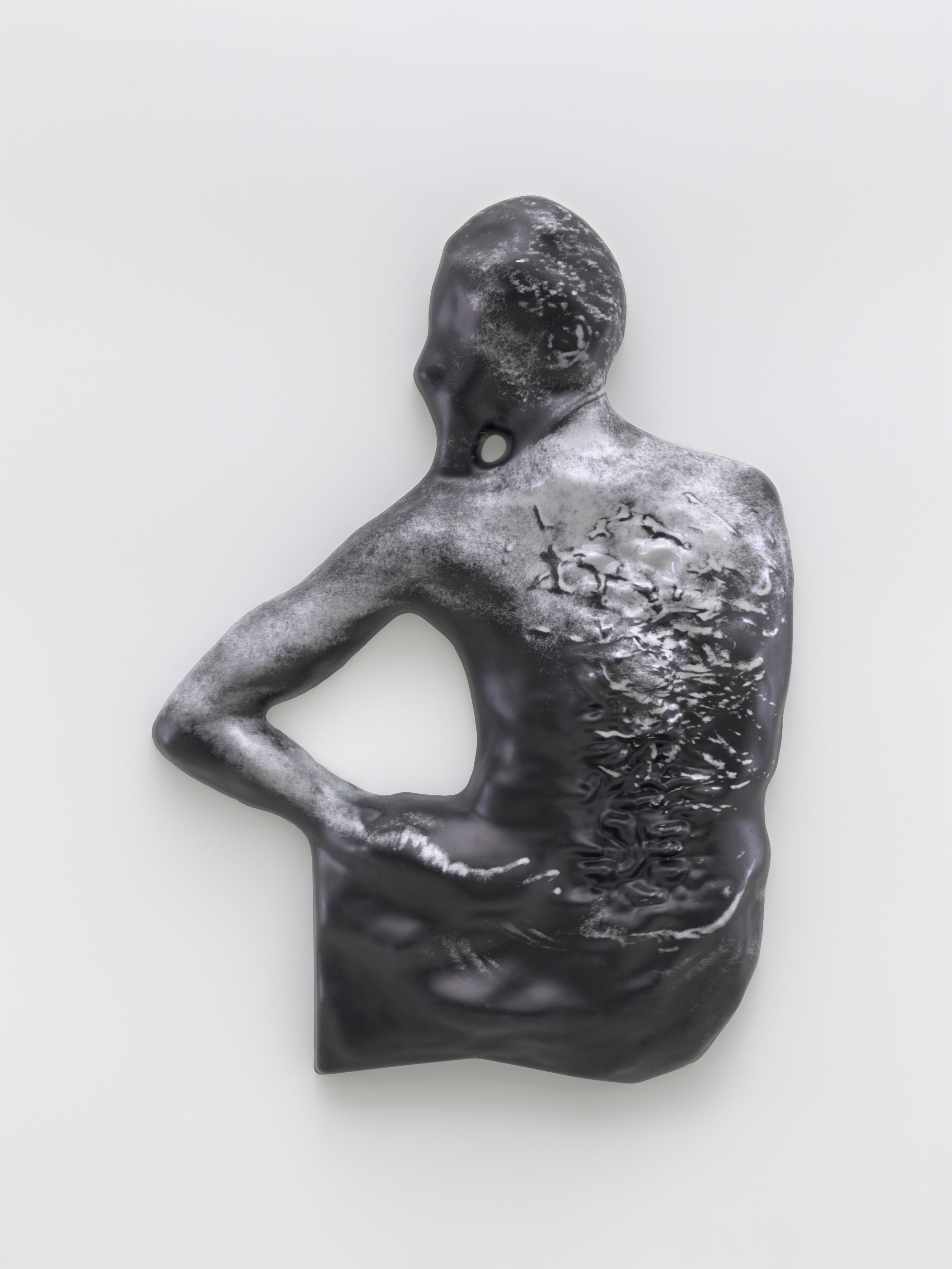 A vacuum-formed plastic image of a Black man's scarred back hangs on a gallery wall.