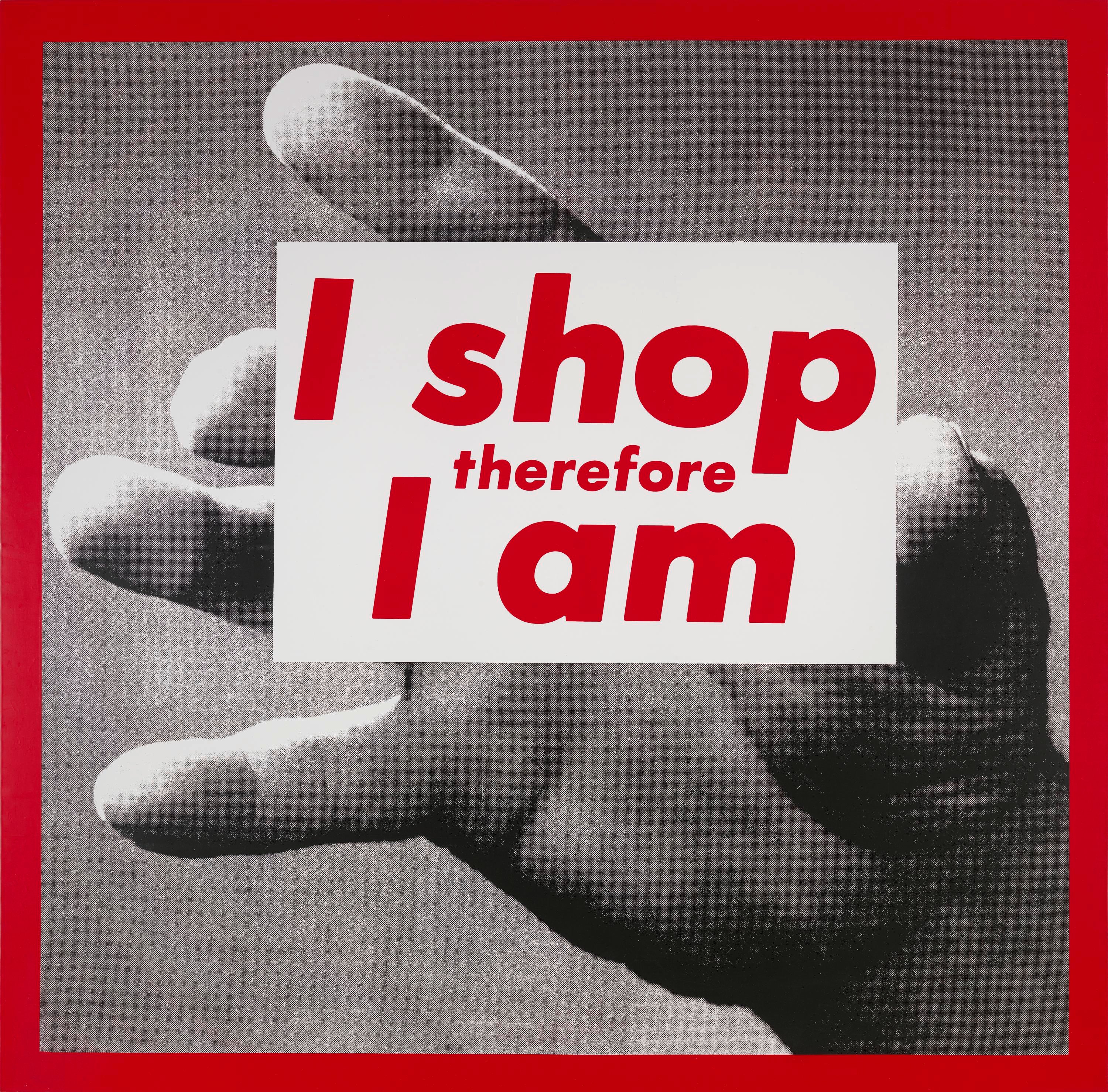 Red outlined black and white photo of a hand holding a white block with red text that says I shop therefore I am.