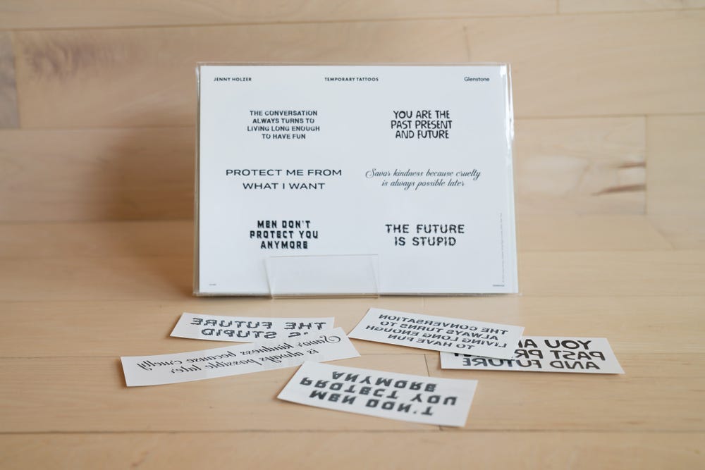 A selection of temporary tattoos sits on a wooden surface.